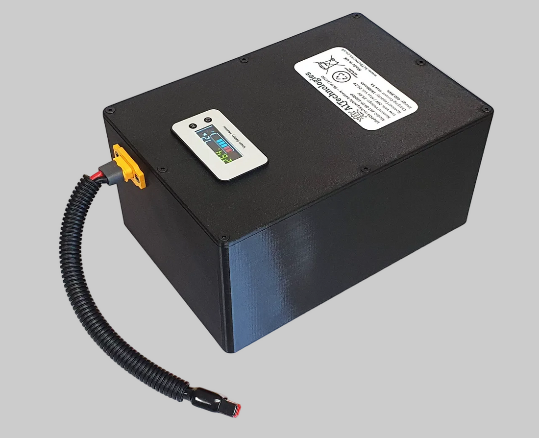 Angled view of ALTechnologies battery case with LED display and connected adapter lead.
